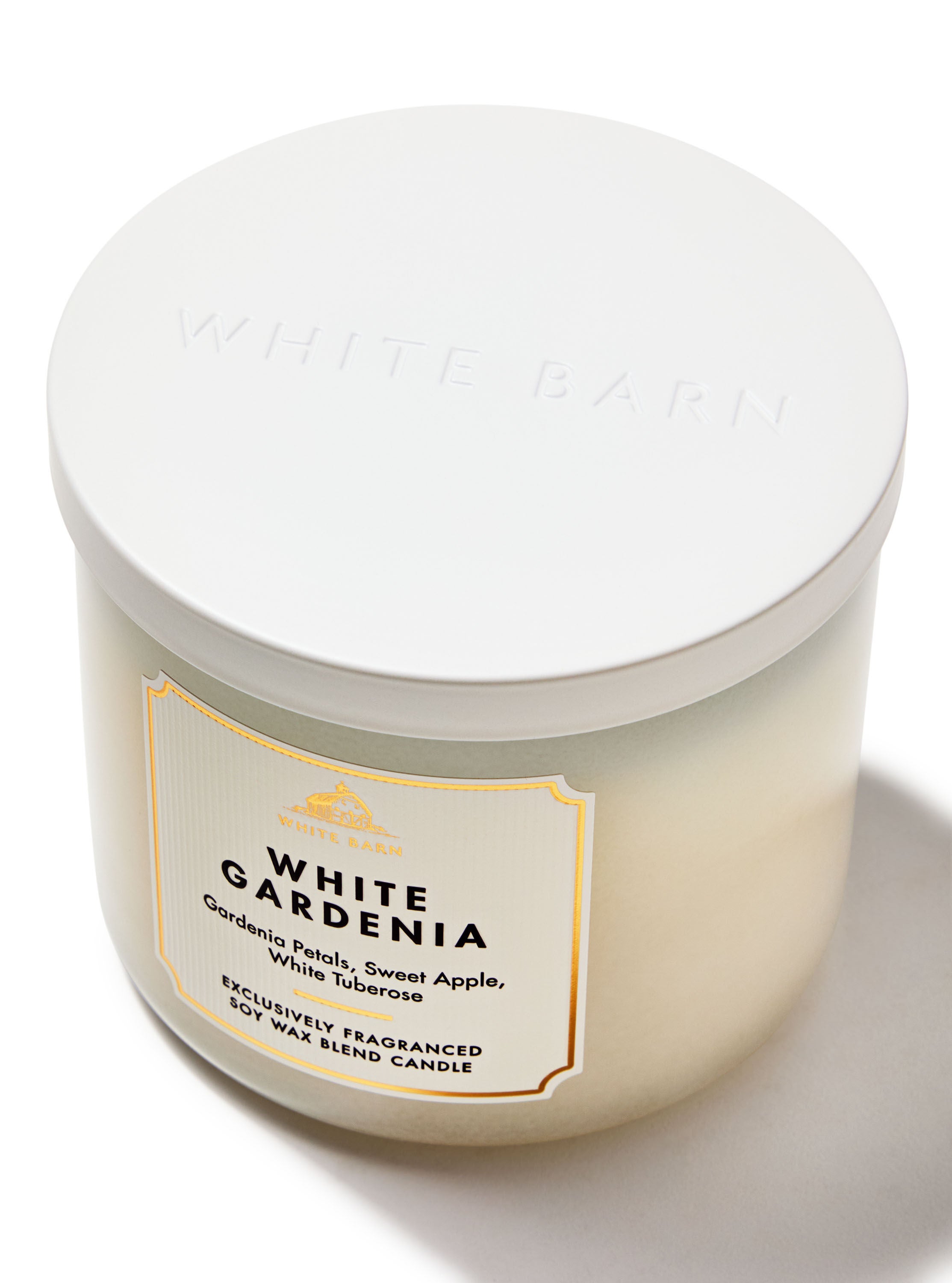 A white jarred candle with a lid