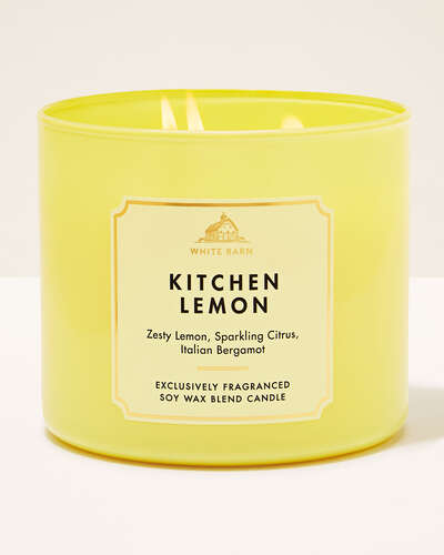 A yellow jarred three wick candle