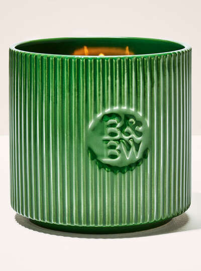 A green glass jar candle