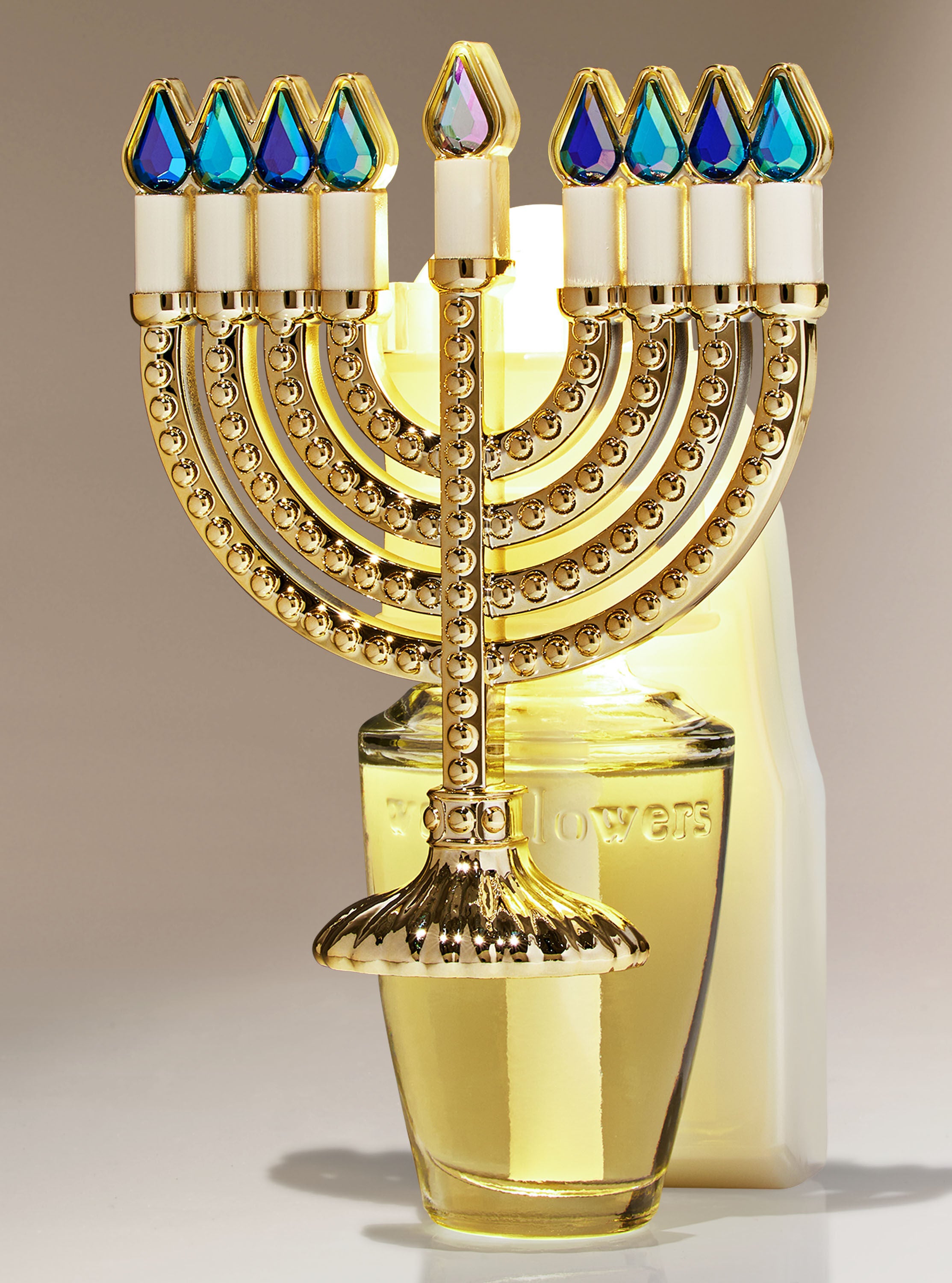 A gold and blue menorah fragrance plug