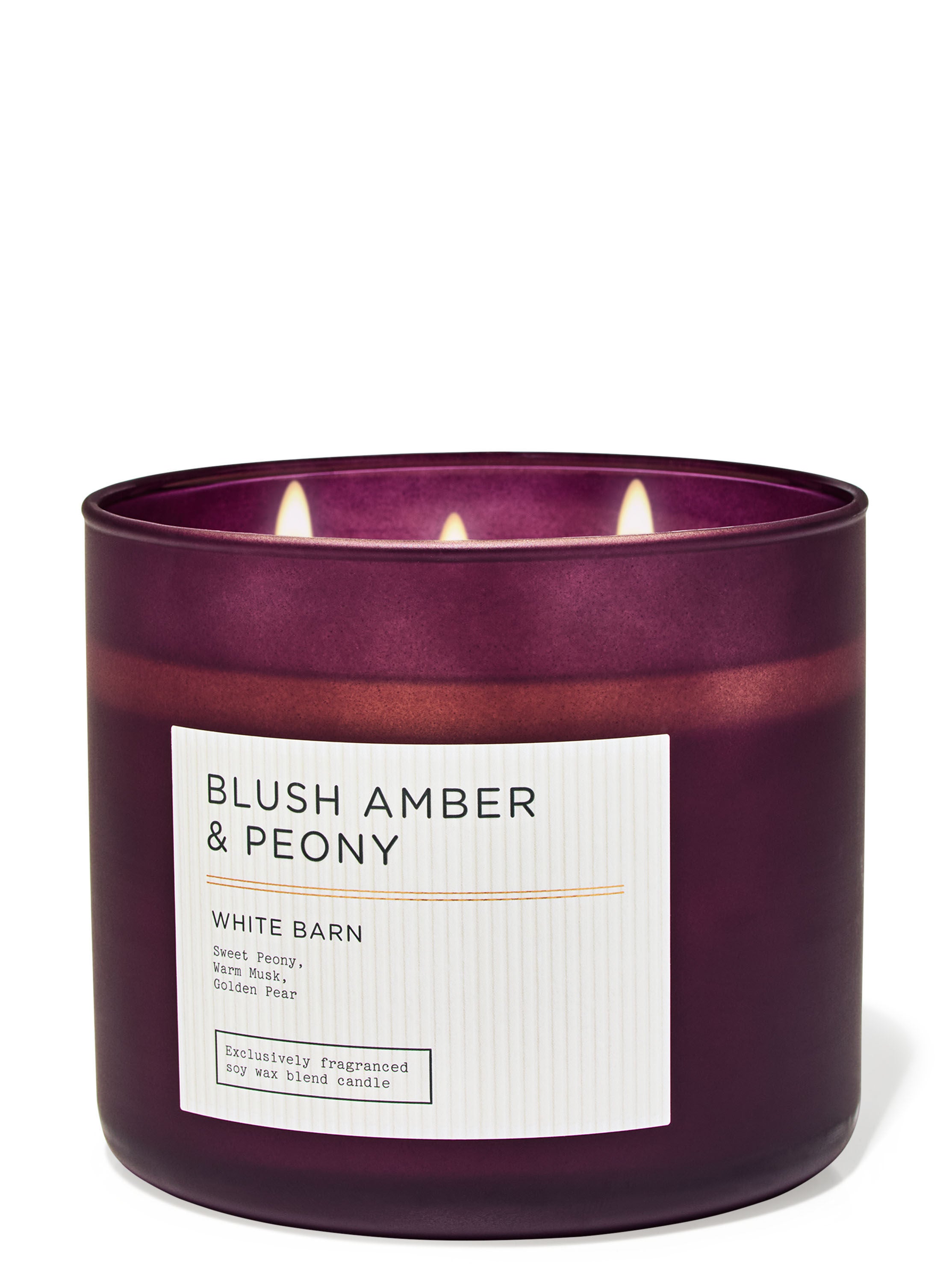 A purple jarred three wick candle with a white label